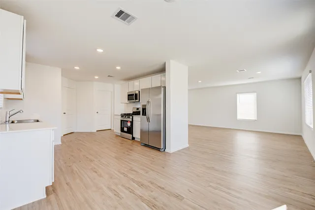 a view of kitchen with refrigerator and window
