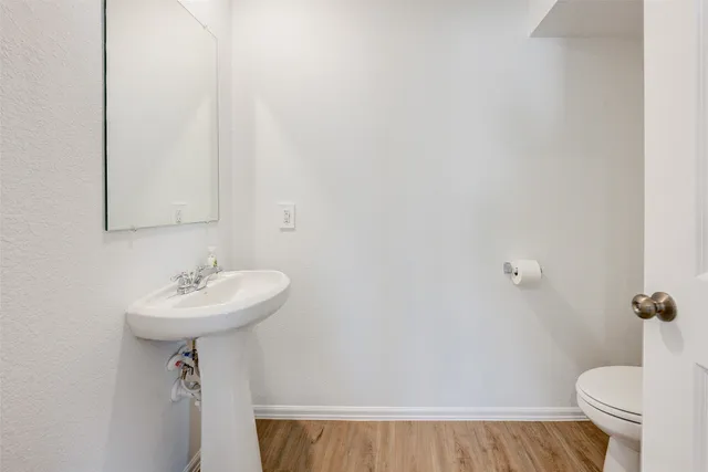a bathroom with a sink toilet and a mirror