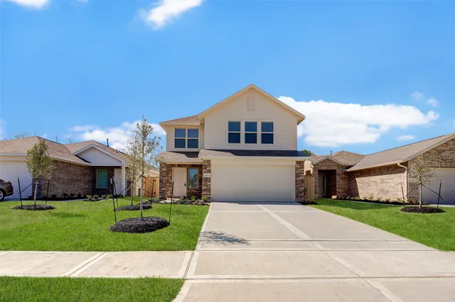 a front view of house with yard and green space