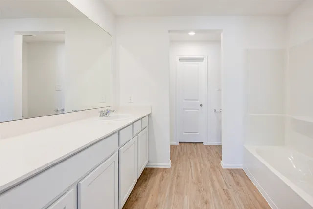 a bathroom with a sink a bathtub and a shower