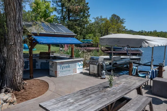 a view of backyard with swimming pool and outdoor seating