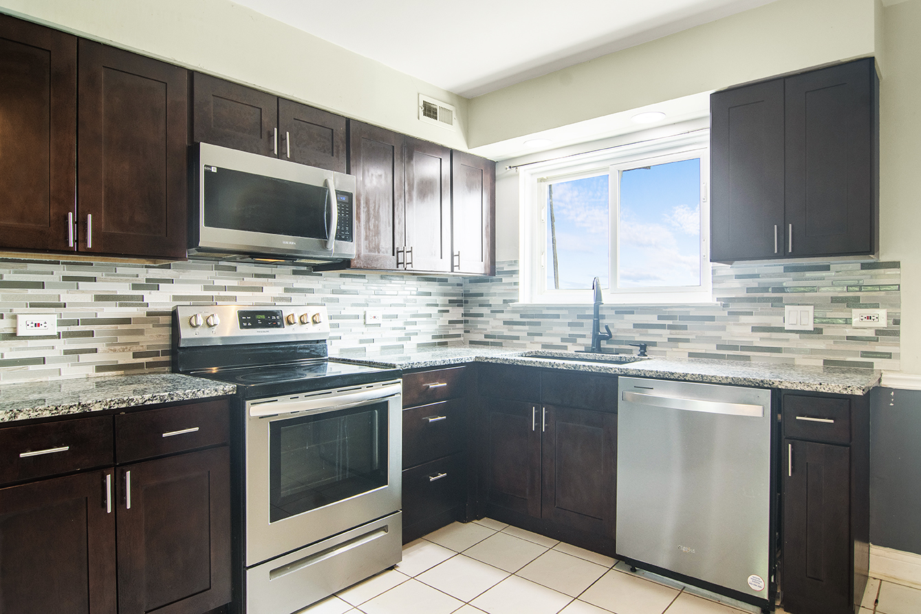 9390 Bay Colony Drive, Unit 3N Des Plaines, IL 60016 - Photo 3 of 15 a kitchen with stainless steel appliances granite countertop a sink stove and microwave