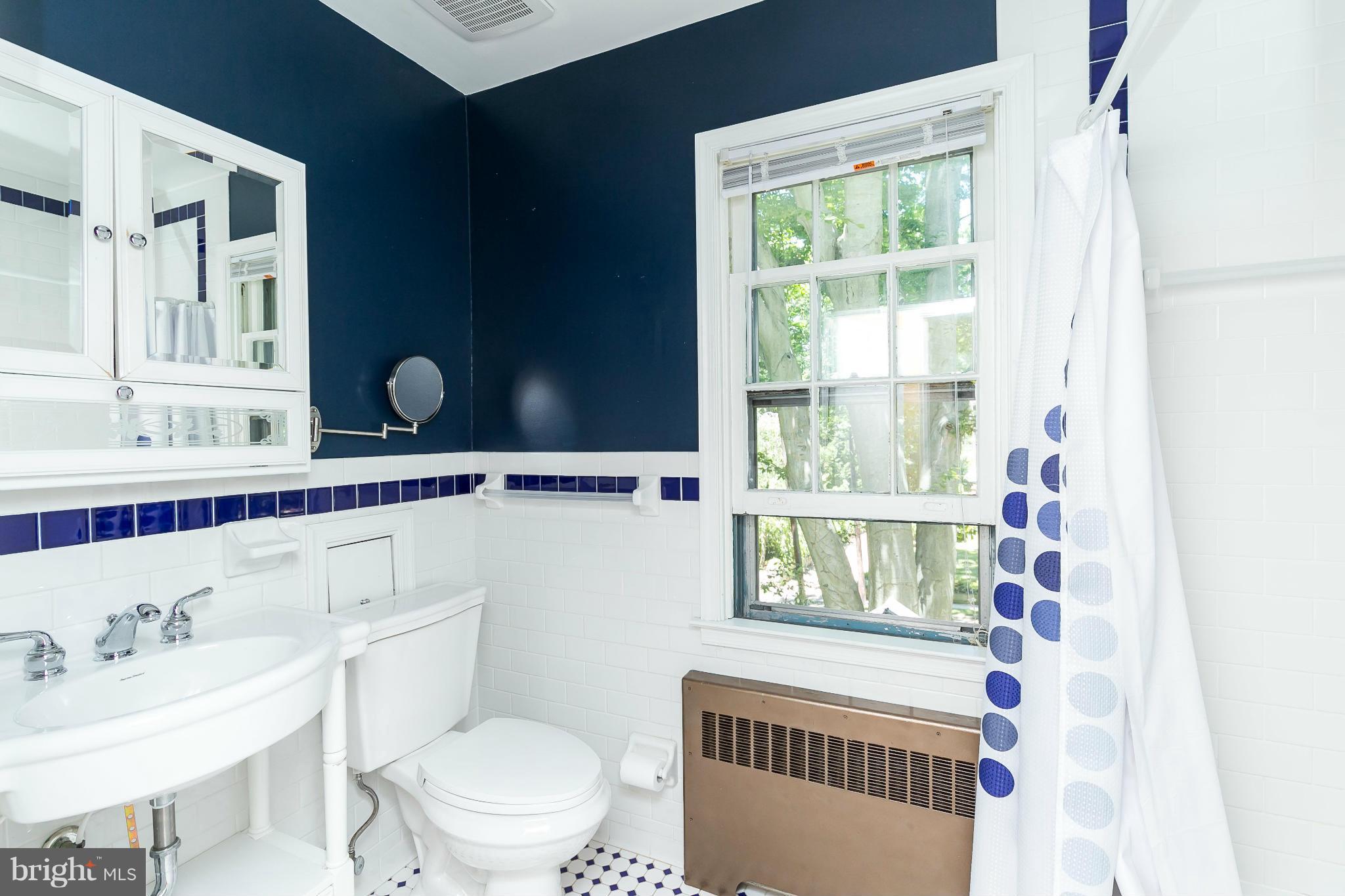 2215 Arden Road Baltimore, MD 21209 - Photo 19 of 30 Crisp navy and white tile in the updated bathroom