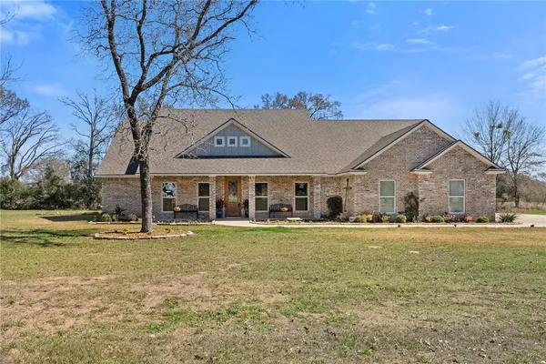 a front view of a building with a garden