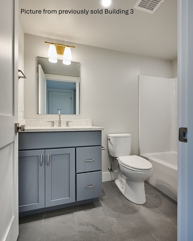 10 Hawley Street, Unit 4C Northampton, MA 01060 - Photo 15 of 23 a bathroom with a toilet a sink and mirror