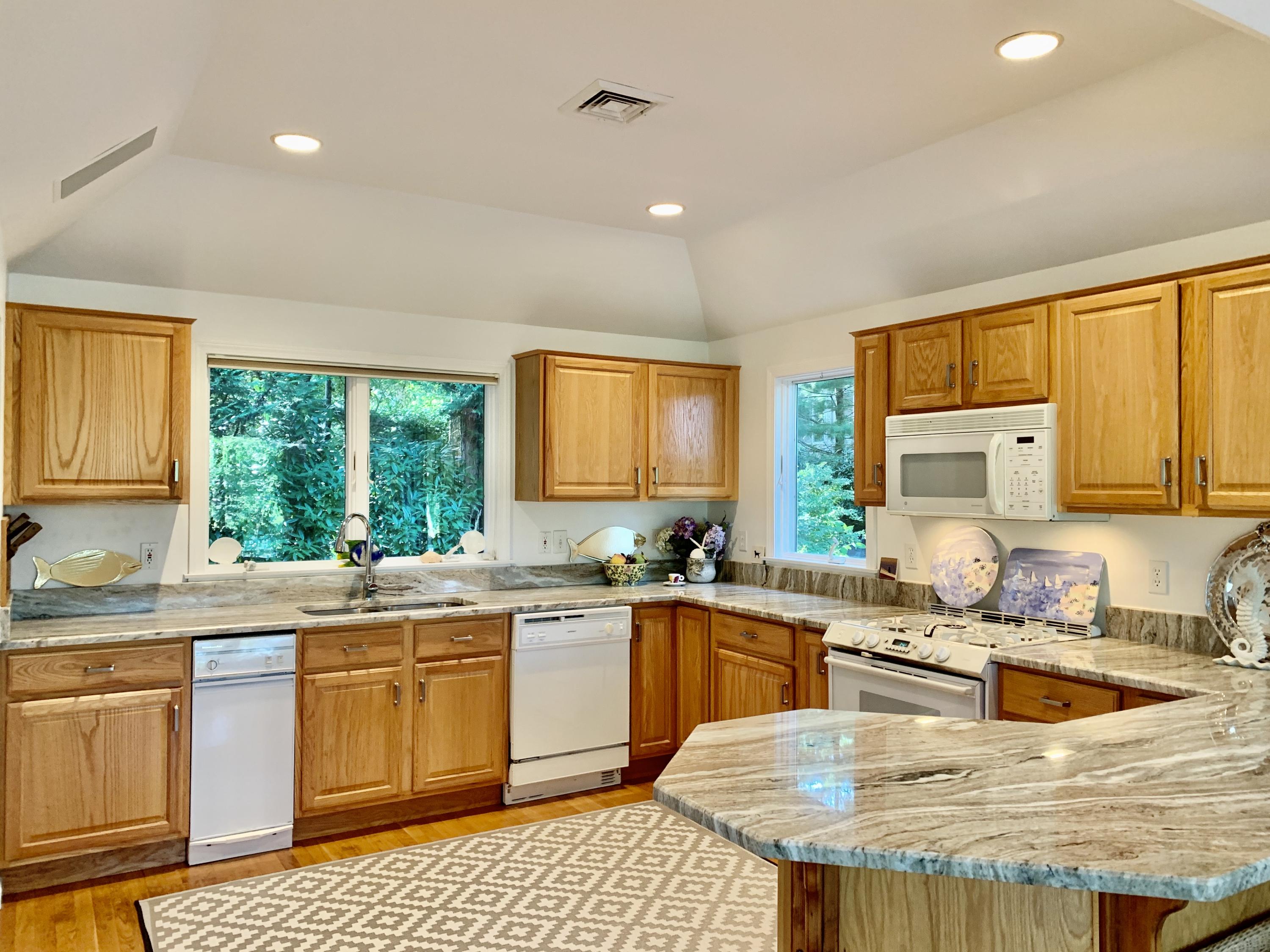120 Fells Pond Road Mashpee, MA 02649 - Photo 16 of 42 a kitchen with a sink stove and cabinets