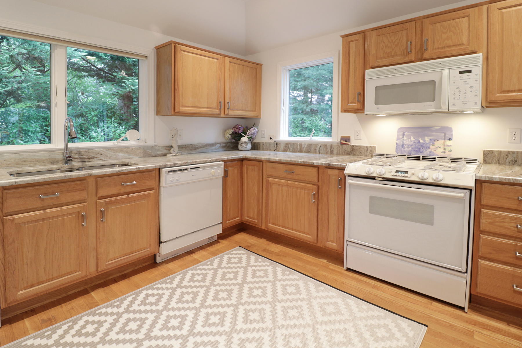 120 Fells Pond Road Mashpee, MA 02649 - Photo 17 of 42 a kitchen with a stove sink and cabinets