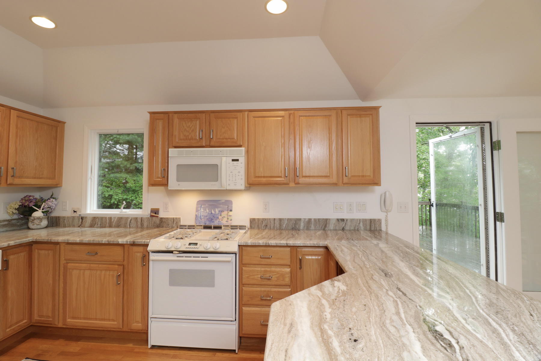 120 Fells Pond Road Mashpee, MA 02649 - Photo 19 of 42 a kitchen with a sink stove and cabinets