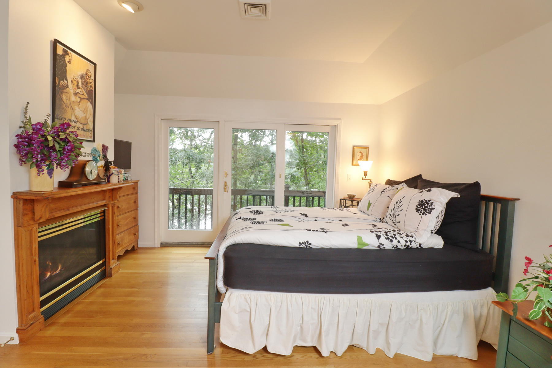 120 Fells Pond Road Mashpee, MA 02649 - Photo 20 of 42 a large bed sitting in a bedroom next to a window with a flat screen tv