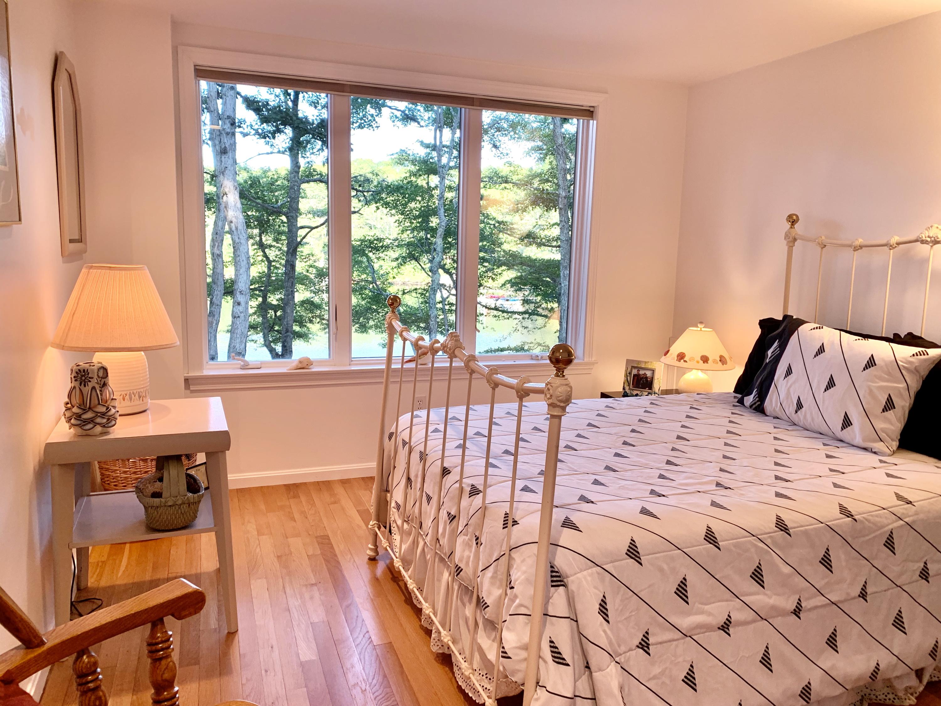 120 Fells Pond Road Mashpee, MA 02649 - Photo 30 of 42 a bedroom with a bed and wooden floor