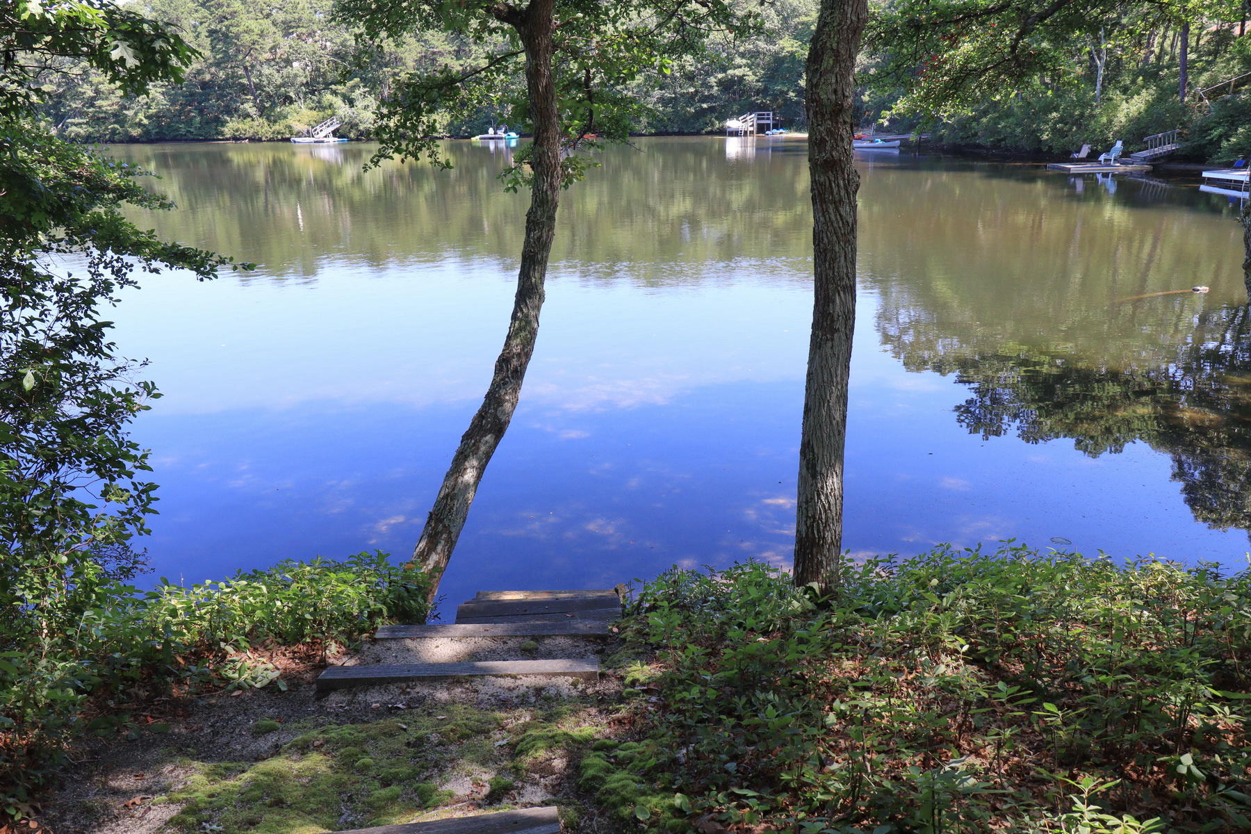 120 Fells Pond Road Mashpee, MA 02649 - Photo 33 of 42 a view of a lake with a building in the background and lake view