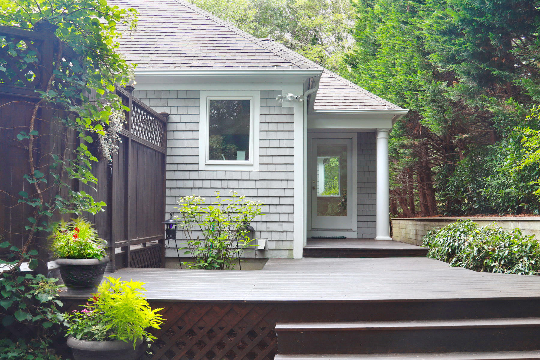 120 Fells Pond Road Mashpee, MA 02649 - Photo 4 of 42 a front view of a house with potted plants