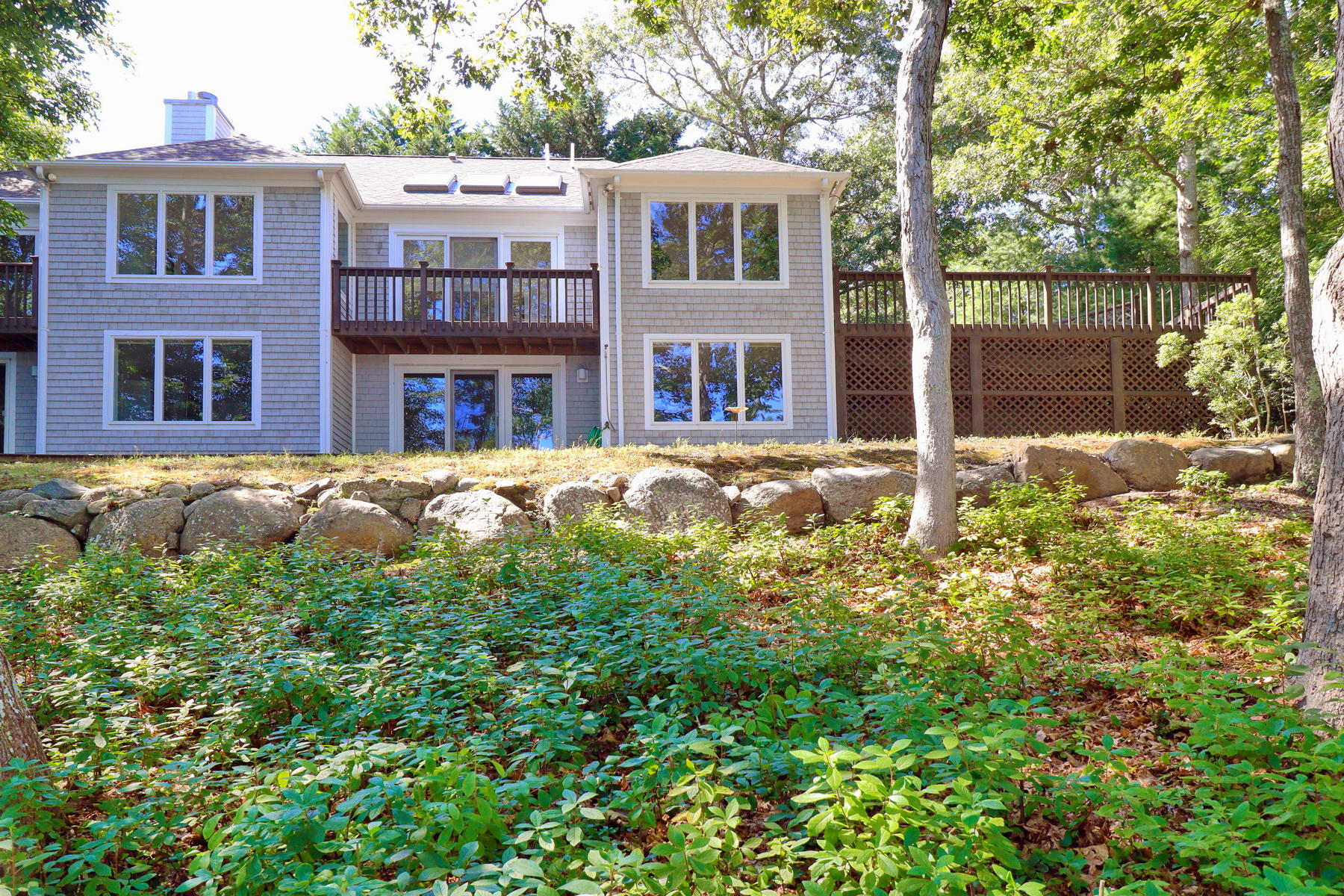 120 Fells Pond Road Mashpee, MA 02649 - Photo 5 of 42 a front view of a house with a yard