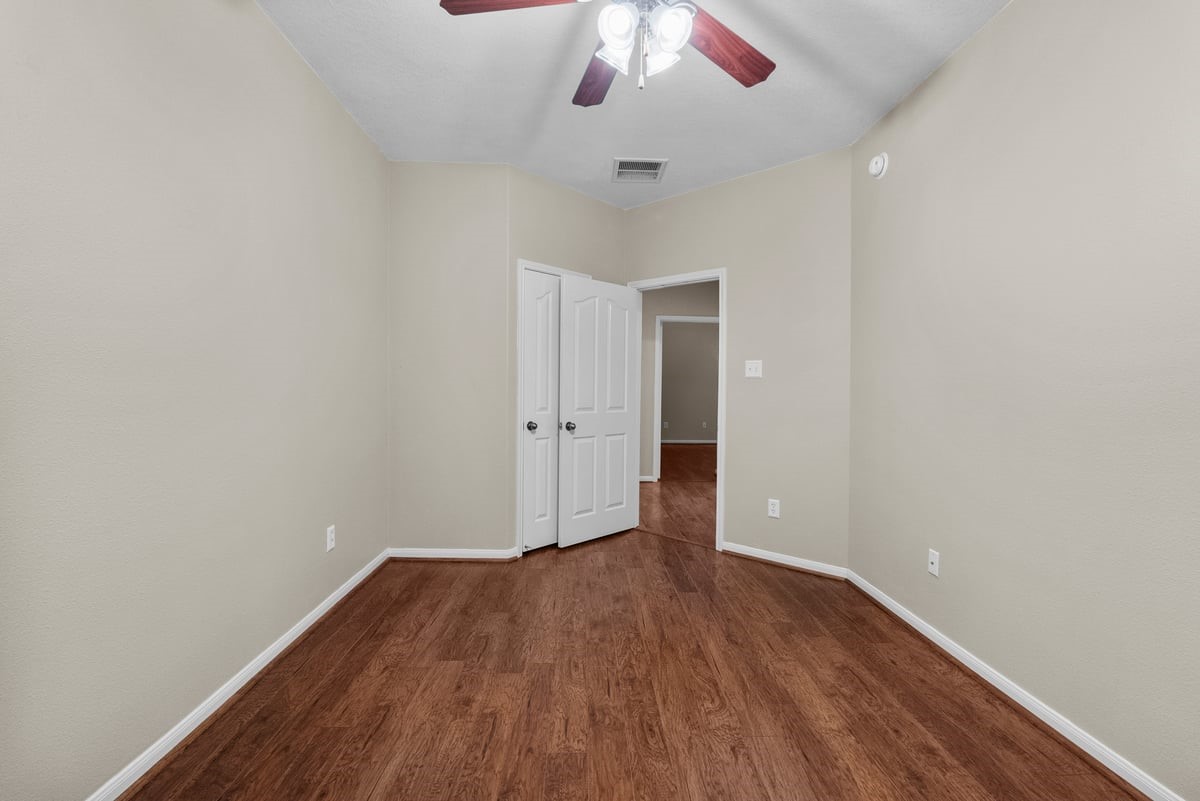 2231 Water Way Seabrook, TX 77586 - Photo 16 of 43 an empty room with wooden floor and windows