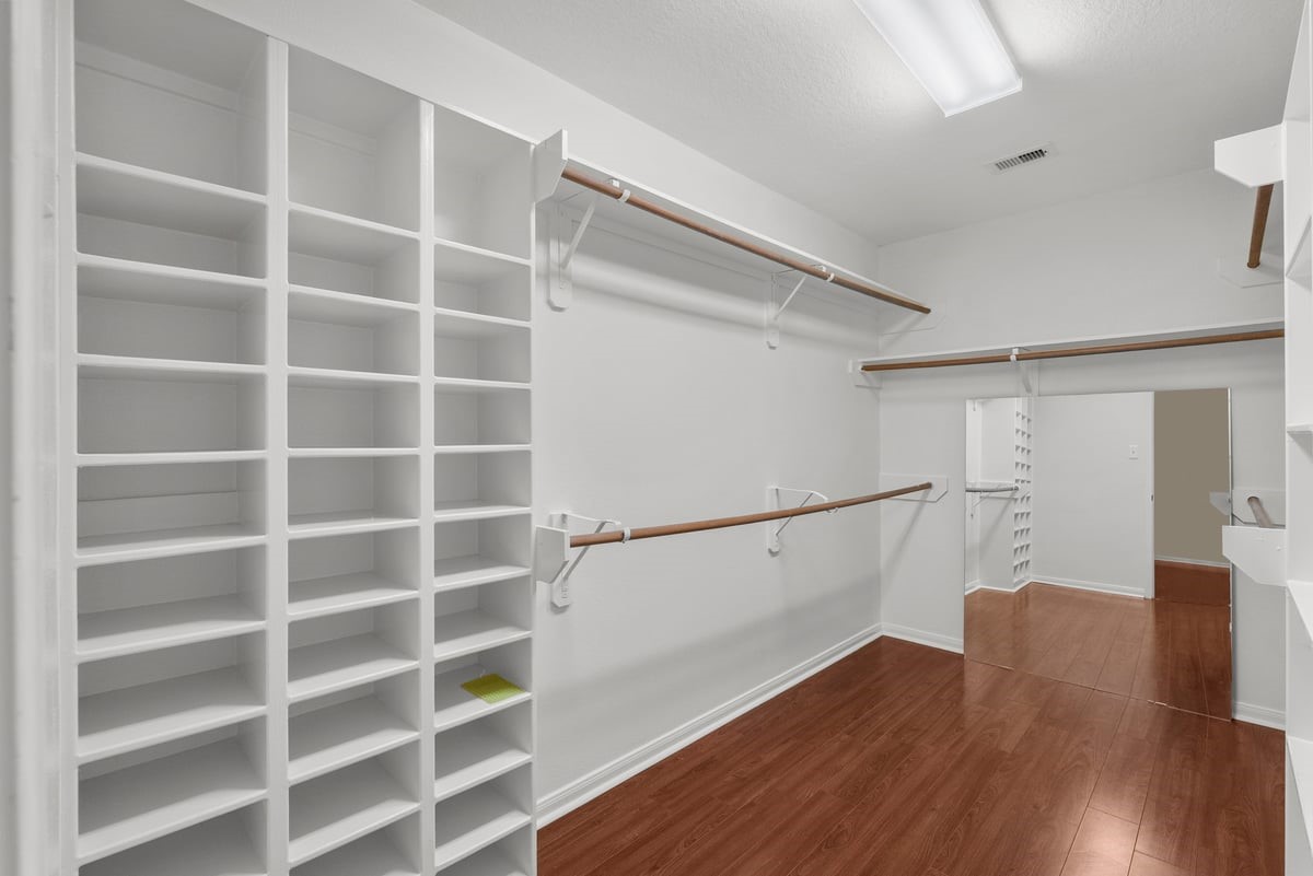 2231 Water Way Seabrook, TX 77586 - Photo 27 of 43 a view of an empty walk in closet and wooden floor