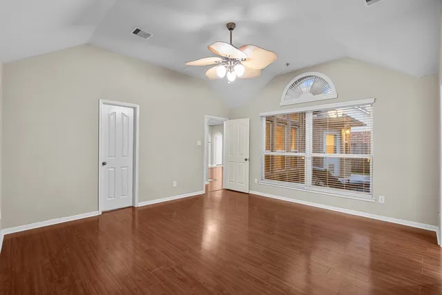 an aerial view of residential houses with city and green space