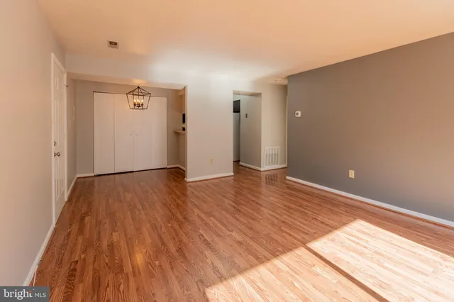 a view of empty room with wooden floor