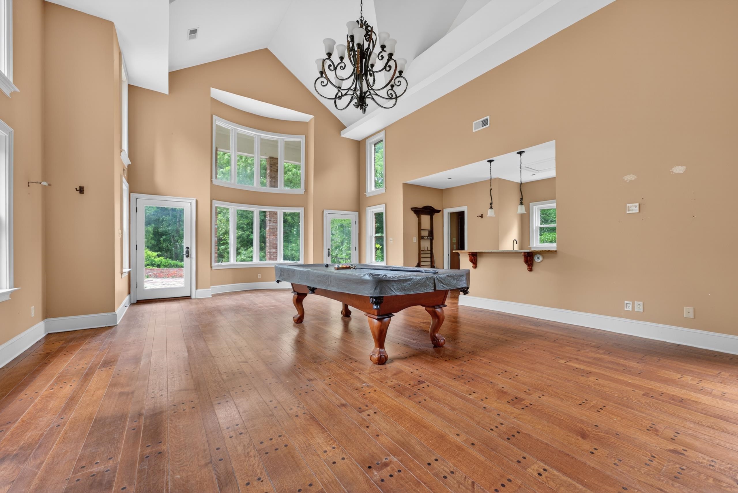 530 West Raines Road Memphis, TN 38109 - Photo 38 of 38 Expansive room featuring rich wood-finish flooring, soaring vaulted ceilings, and a decorative chandelier