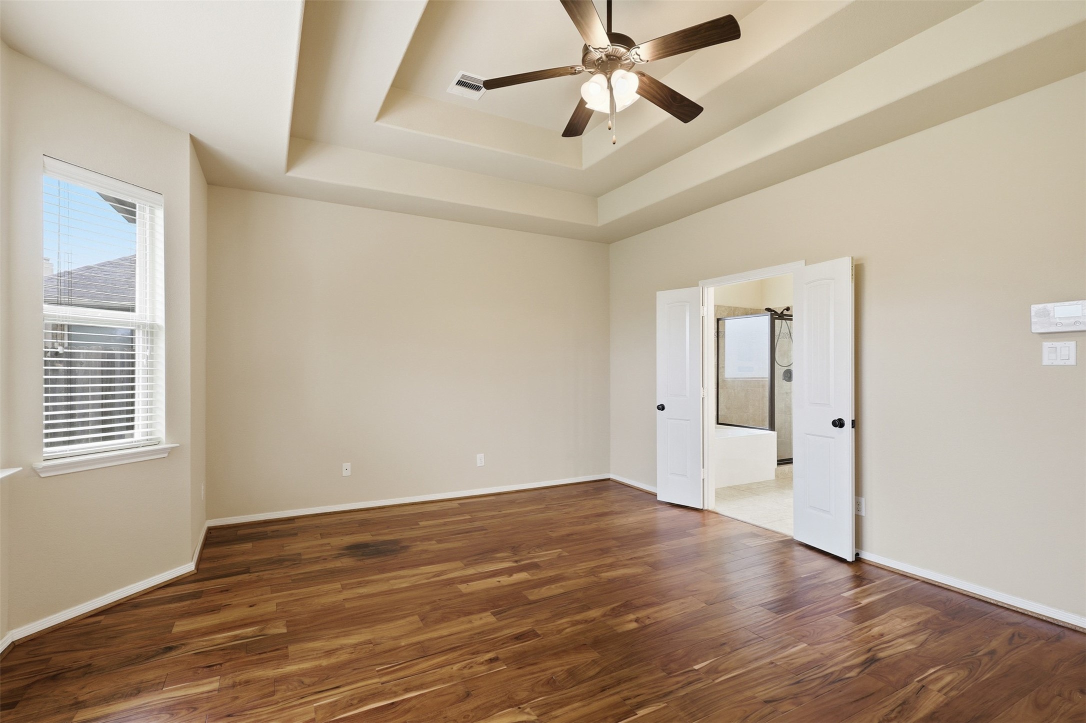 22943 Dale River Road Tomball, TX 77375 - Photo 16 of 29 a view of an empty room with wooden floor and a window