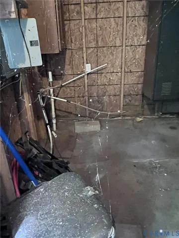 a room with water heater and wooden cabinets
