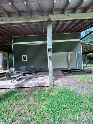 a view of a chair and table in backyard of the house