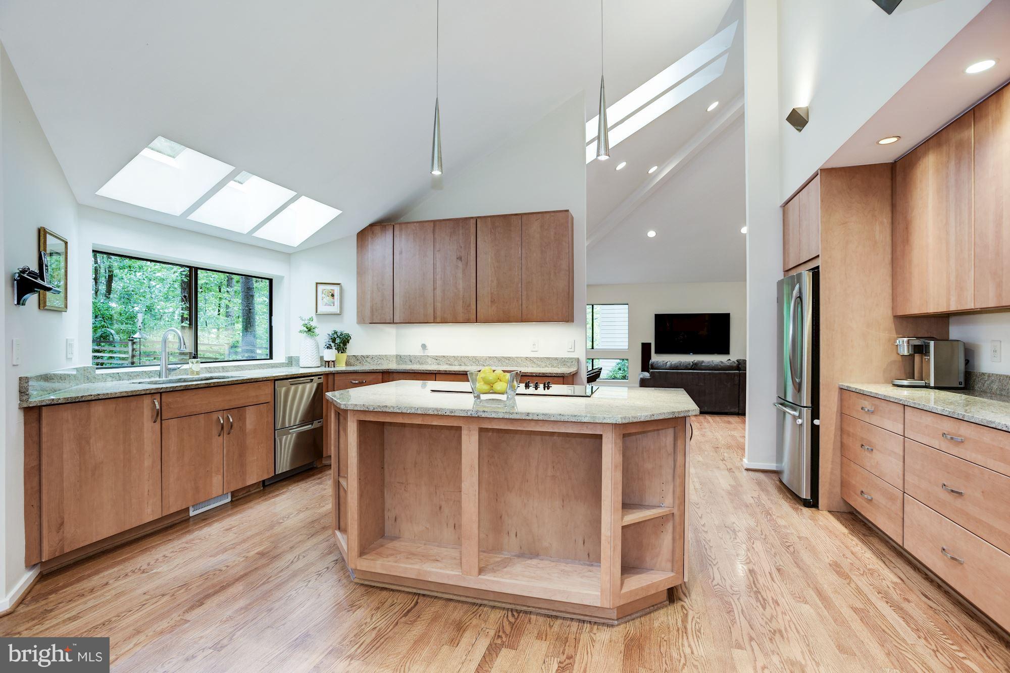 2119 Owls Cove Lane Reston, VA 20191 - Photo 10 of 30 a kitchen with kitchen island a stove a sink a refrigerator cabinets and wooden floor