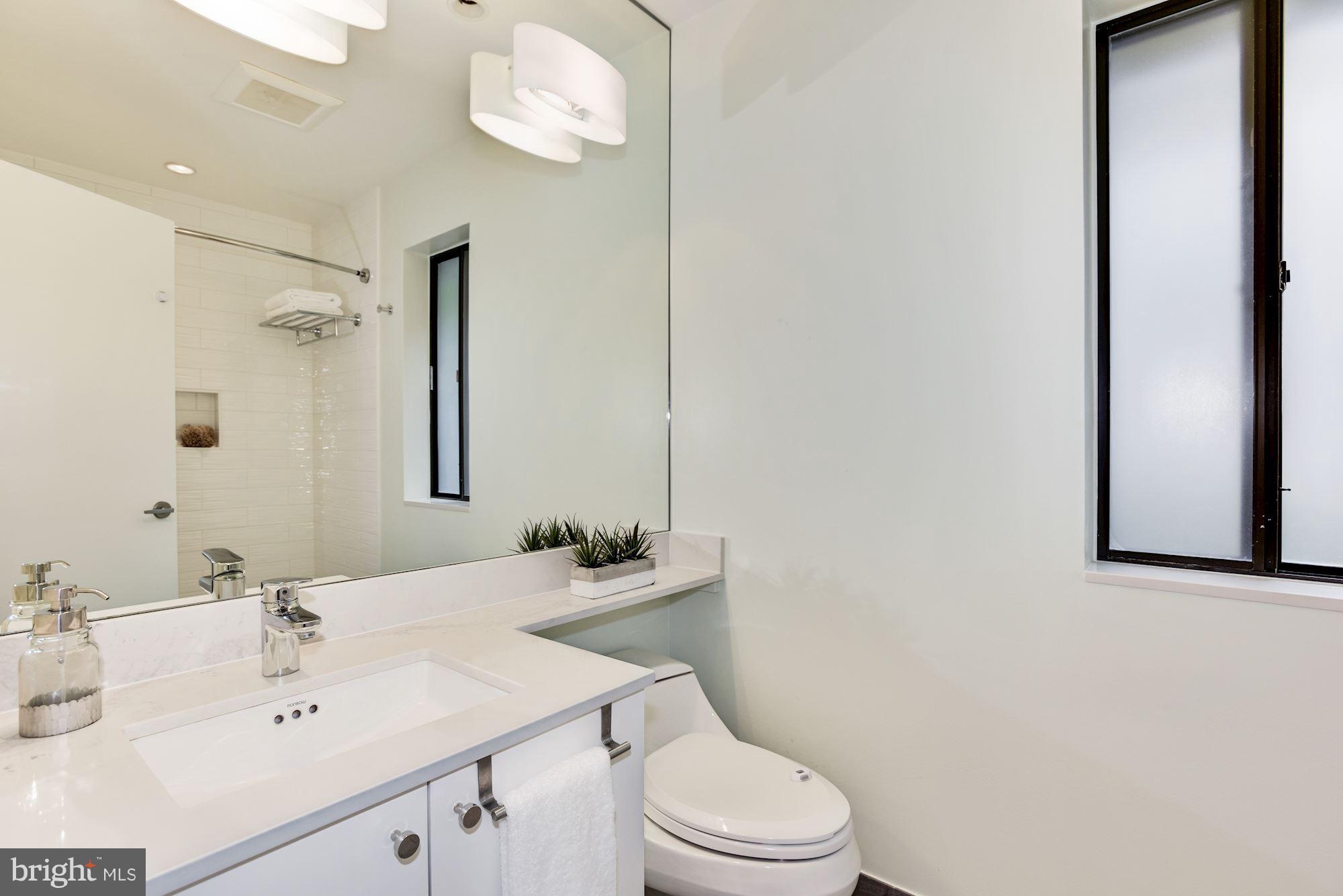 2119 Owls Cove Lane Reston, VA 20191 - Photo 22 of 30 a bathroom with a sink a toilet and shower