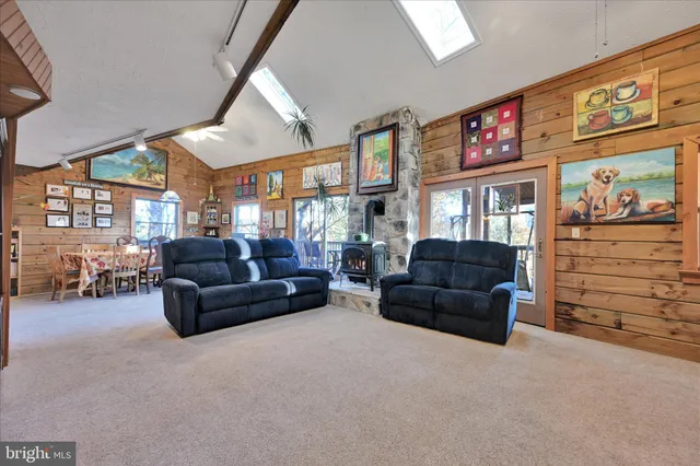 a living room with furniture a couch and dresser next to a window