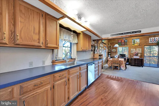 a kitchen with sink cabinets and wooden floor