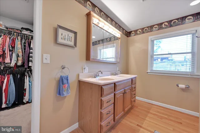 a bedroom with a bed a book shelf and a window