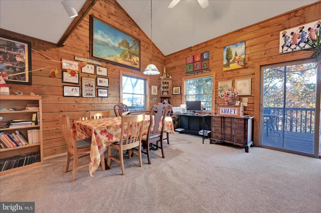 a dining room with furniture and a floor to ceiling window
