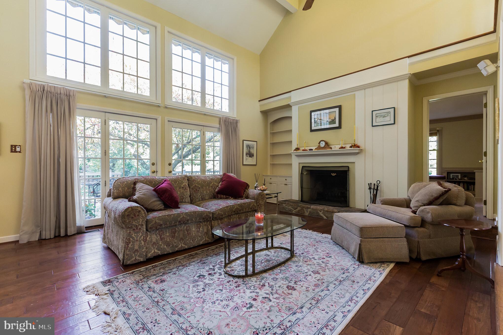 880 Springbank Lane Wayne, PA 19087 - Photo 14 of 43 a living room with furniture a large window and a fireplace