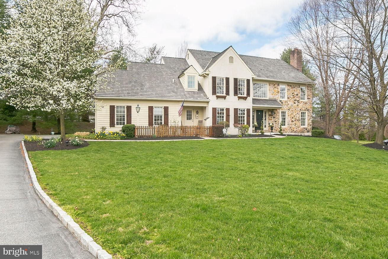 880 Springbank Lane Wayne, PA 19087 - Photo 3 of 43 a front view of a house with a garden and trees