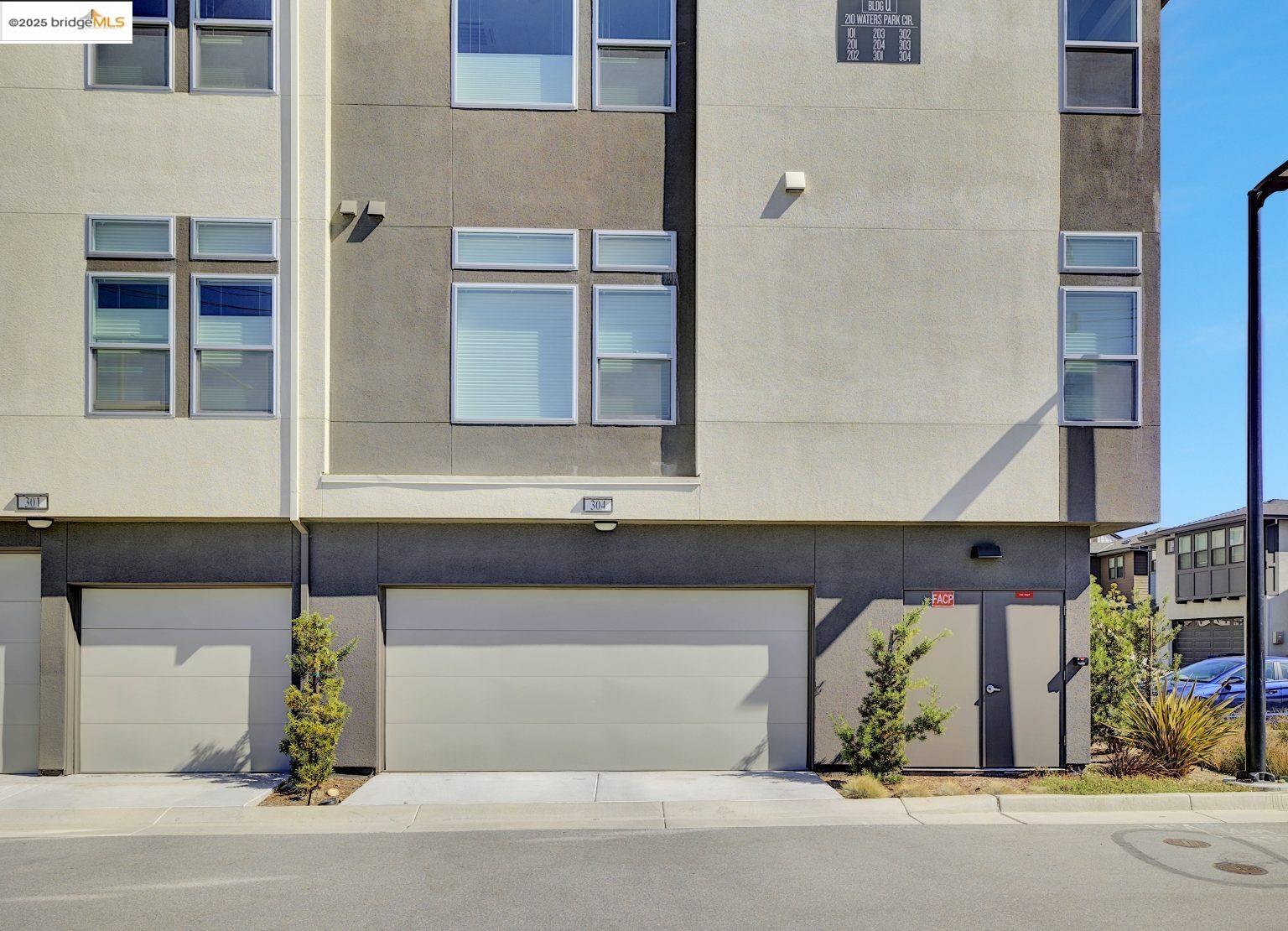 210 Waters Park Circle, Unit 304 San Mateo, CA 94403 - Photo 15 of 17 a front view of a house with a garage