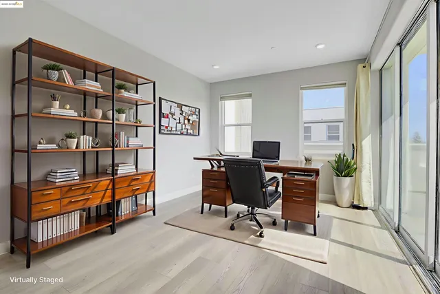 a view of a workspace with furniture and a window