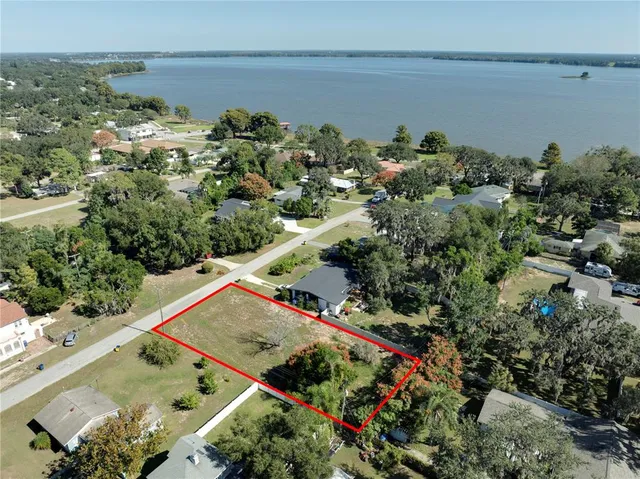 an aerial view of a house with a lake view