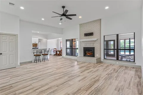 a view of a livingroom with furniture wooden floor and a fireplace