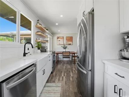 a kitchen with a sink appliances and cabinets