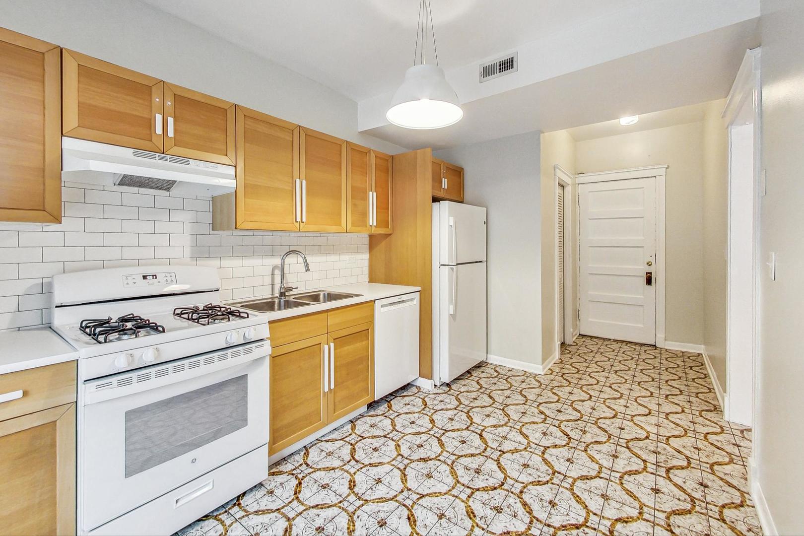 4000 North Hermitage Avenue, Unit 1 Chicago, IL 60613 - Photo 11 of 28 a kitchen with a stove a sink and a refrigerator