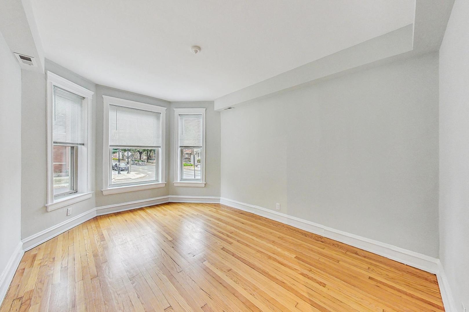 4000 North Hermitage Avenue, Unit 1 Chicago, IL 60613 - Photo 12 of 28 a view of empty room with wooden floor and fan