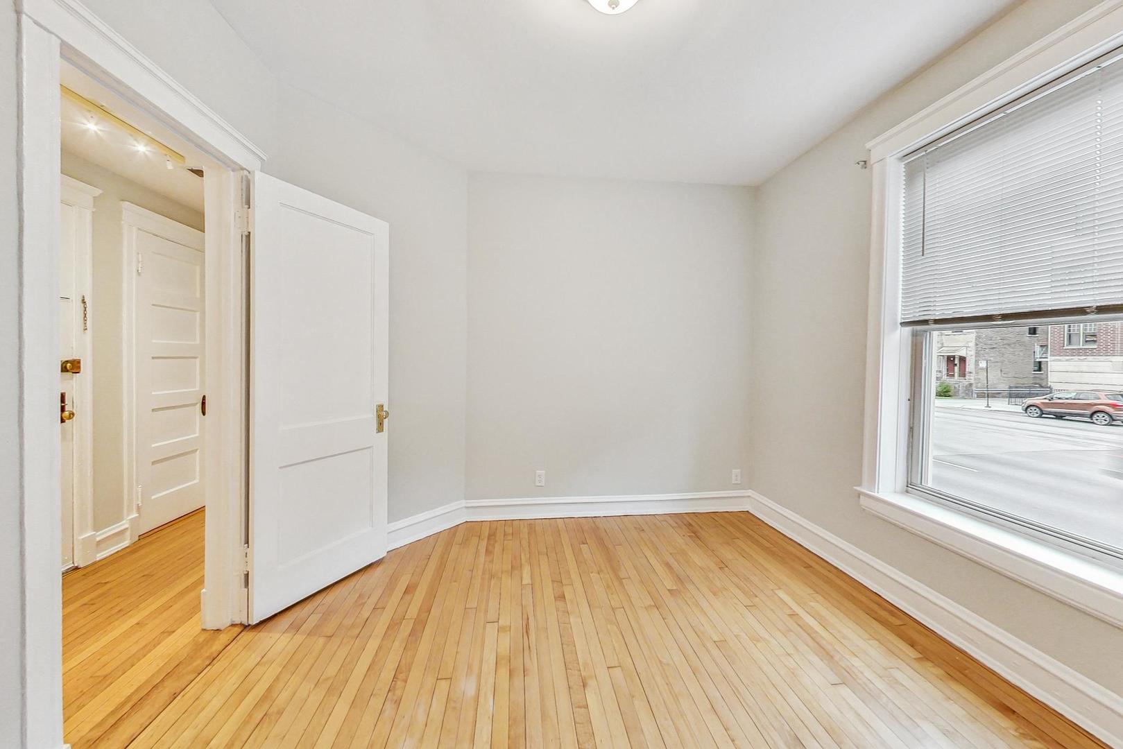 4000 North Hermitage Avenue, Unit 1 Chicago, IL 60613 - Photo 16 of 28 a view of a room with wooden floor and a window