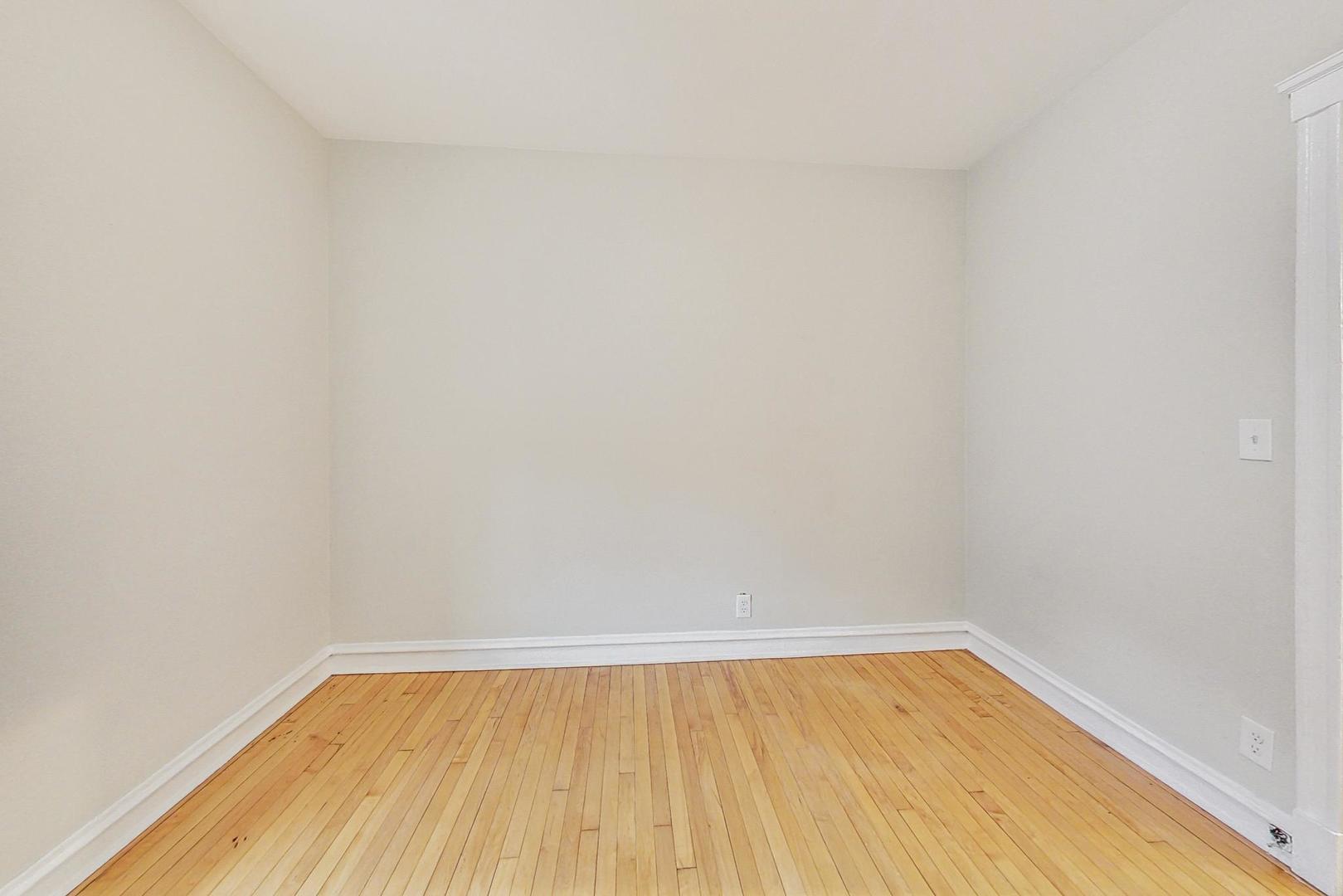 4000 North Hermitage Avenue, Unit 1 Chicago, IL 60613 - Photo 19 of 28 a view of an empty room with wooden floor