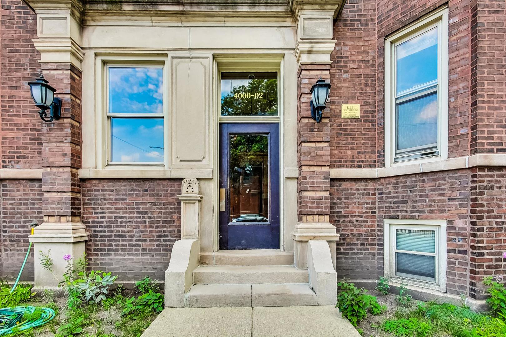 4000 North Hermitage Avenue, Unit 1 Chicago, IL 60613 - Photo 2 of 28 a front view of a house with a garden