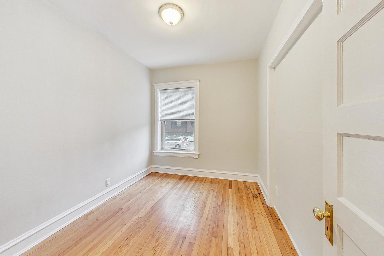 4000 North Hermitage Avenue, Unit 1 Chicago, IL 60613 - Photo 21 of 28 a view of a room with wooden floor and window