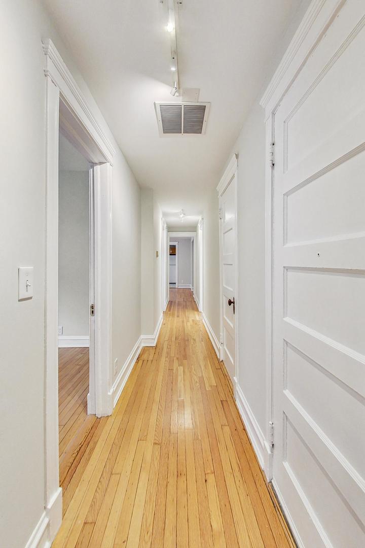 4000 North Hermitage Avenue, Unit 1 Chicago, IL 60613 - Photo 3 of 28 a view of a hallway with wooden floor and staircase