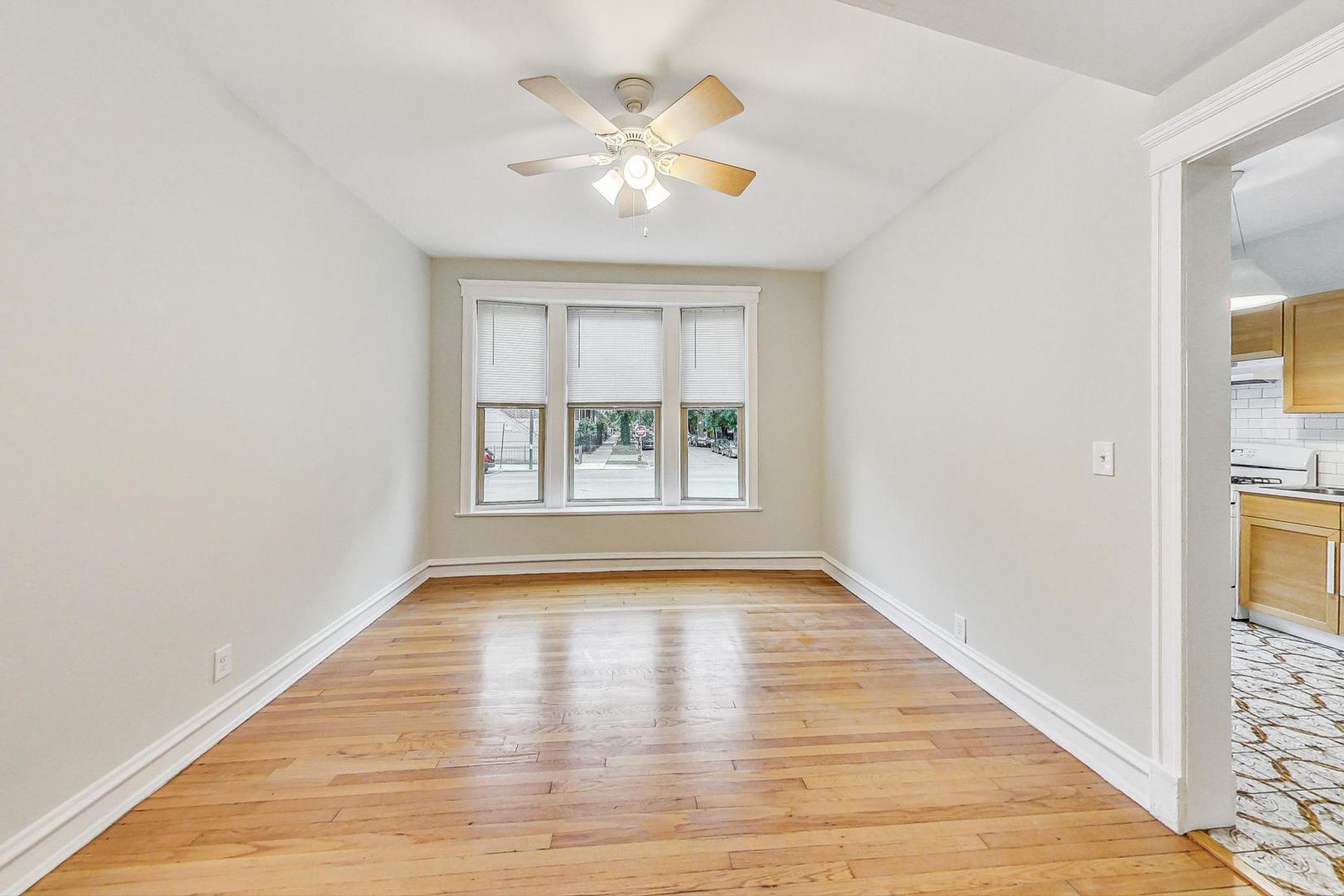 4000 North Hermitage Avenue, Unit 1 Chicago, IL 60613 - Photo 5 of 28 wooden floor in an empty room with a window