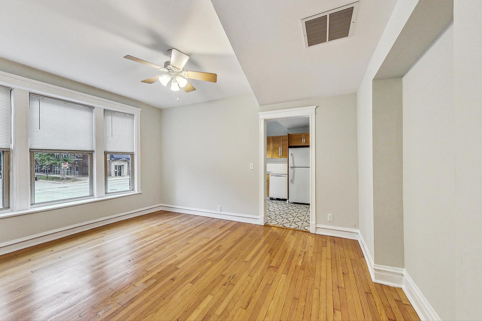 4000 North Hermitage Avenue, Unit 1 Chicago, IL 60613 - Photo 6 of 28 wooden floor in an empty room with a window