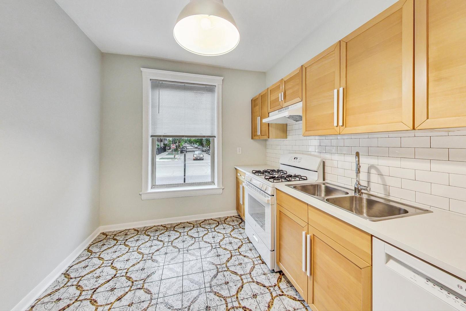 4000 North Hermitage Avenue, Unit 1 Chicago, IL 60613 - Photo 10 of 28 a kitchen with a sink stove and cabinets