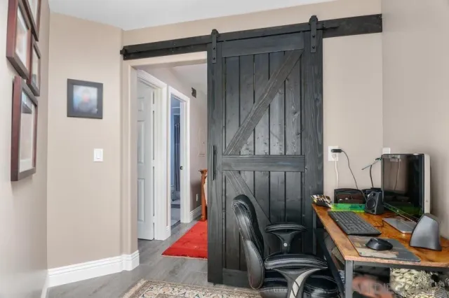 a room with furniture a flat screen tv and a window