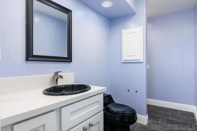 a bathroom with a sink a toilet and mirror